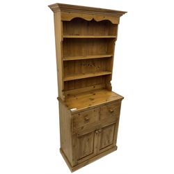 Solid pine dresser, fitted with plate rack above two drawers and two cupboards