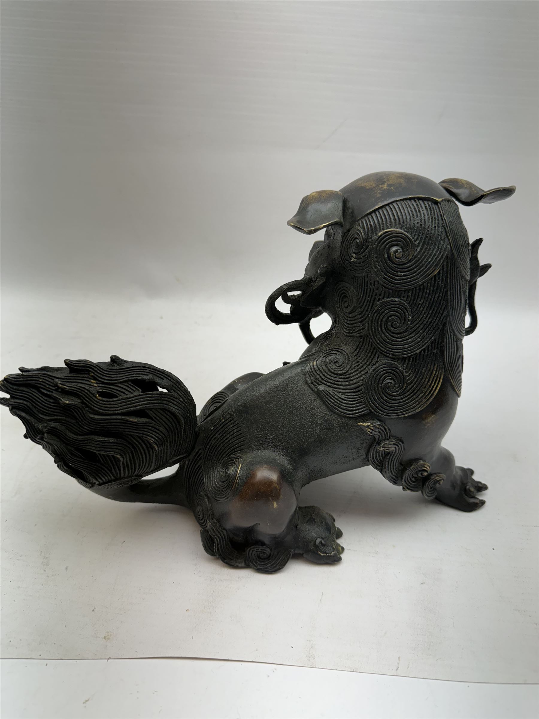 Bronze dog of foo, modelled with one paw placed upon ball, H18cm