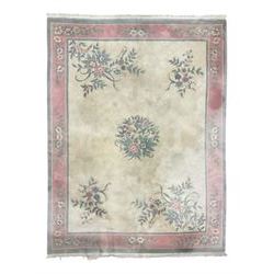 Chinese ivory ground washed woollen carpet, the field decorated with five large floral motifs with extending leafage, the wide rose guard band decorated with further floral patterns