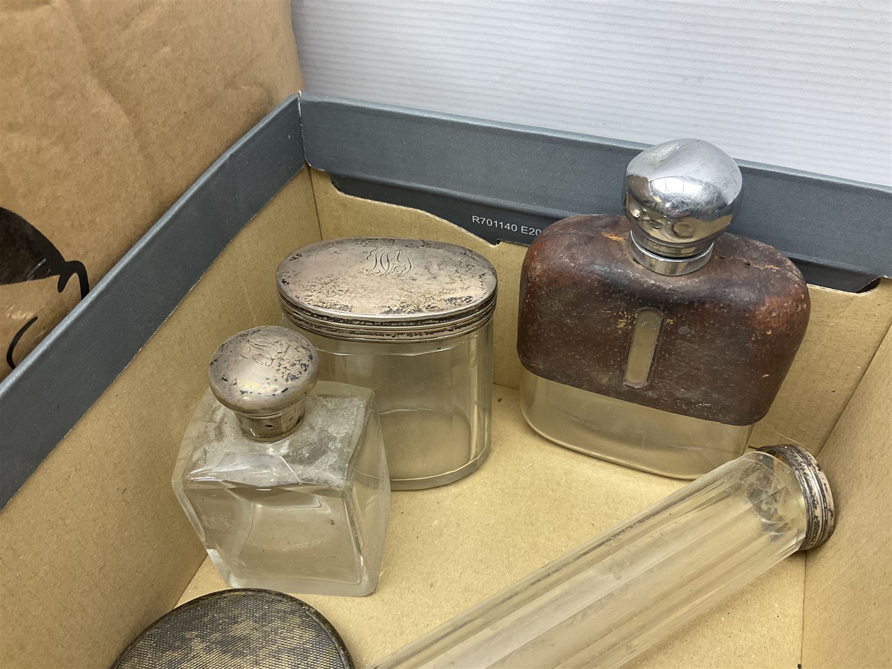 Silver mounted hand mirror and glass vanity bottles/jars with silver caps, all hallmarked, together with silver plated teapot, serving dishes and glass hip flask