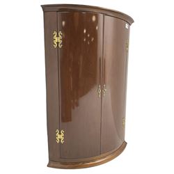 Georgian design mahogany hanging cylinder corner cupboard, fitted with two cupboard doors enclosing two shelves, with gilt metal mounts