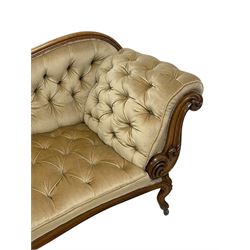 19th century walnut framed chaise longue, shaped back over scrolled arms decorated with moulded curling acanthus carvings, upholstered in deep buttoned champagne fabric, raised on cabriole supports with applied floral carved decoration, on castors