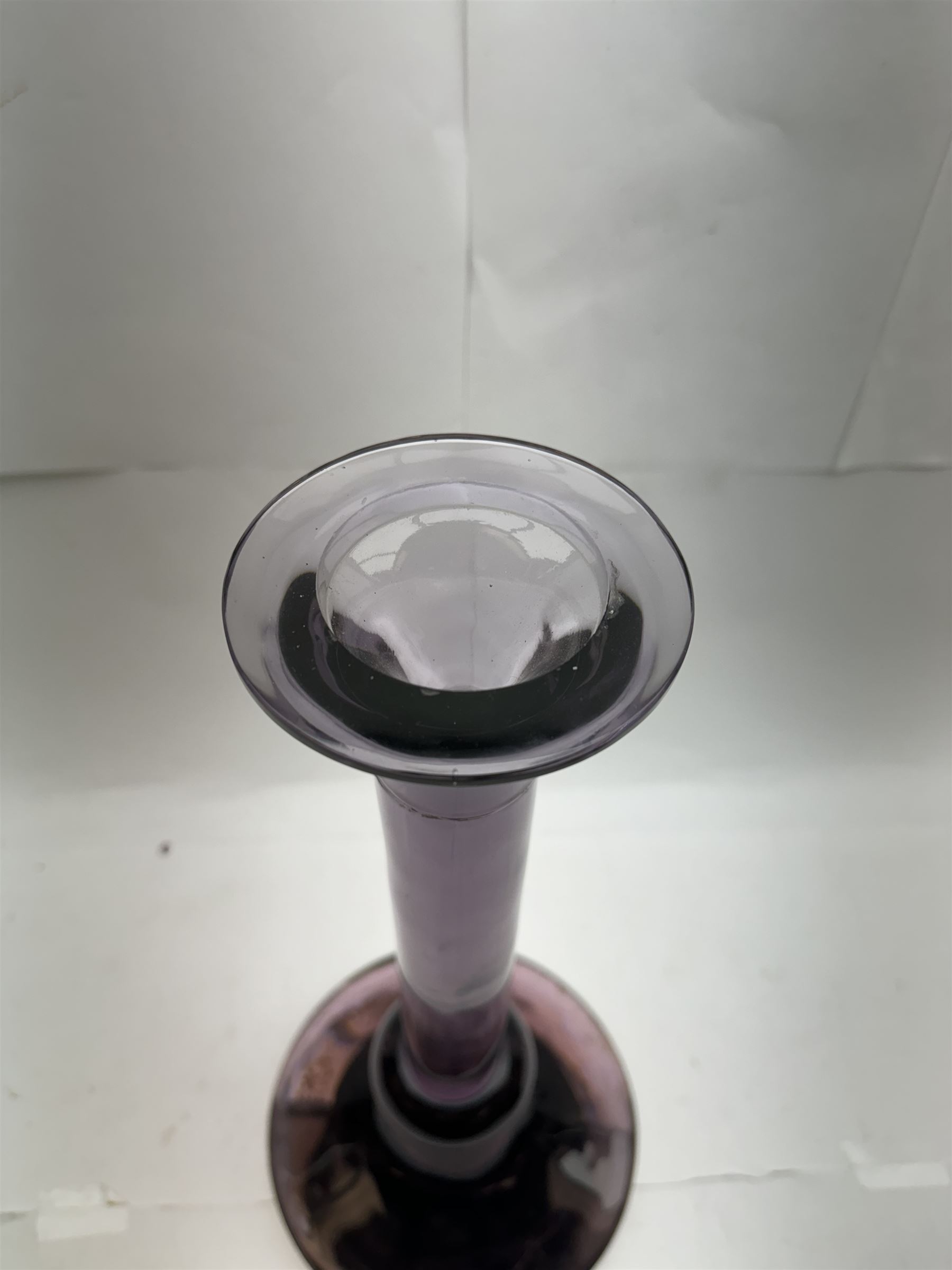 Large heavy gauge Scandinavian amethyst glass candlestick, the plain column with flared rim and basel knop, upon a spreading circular base, H44cm