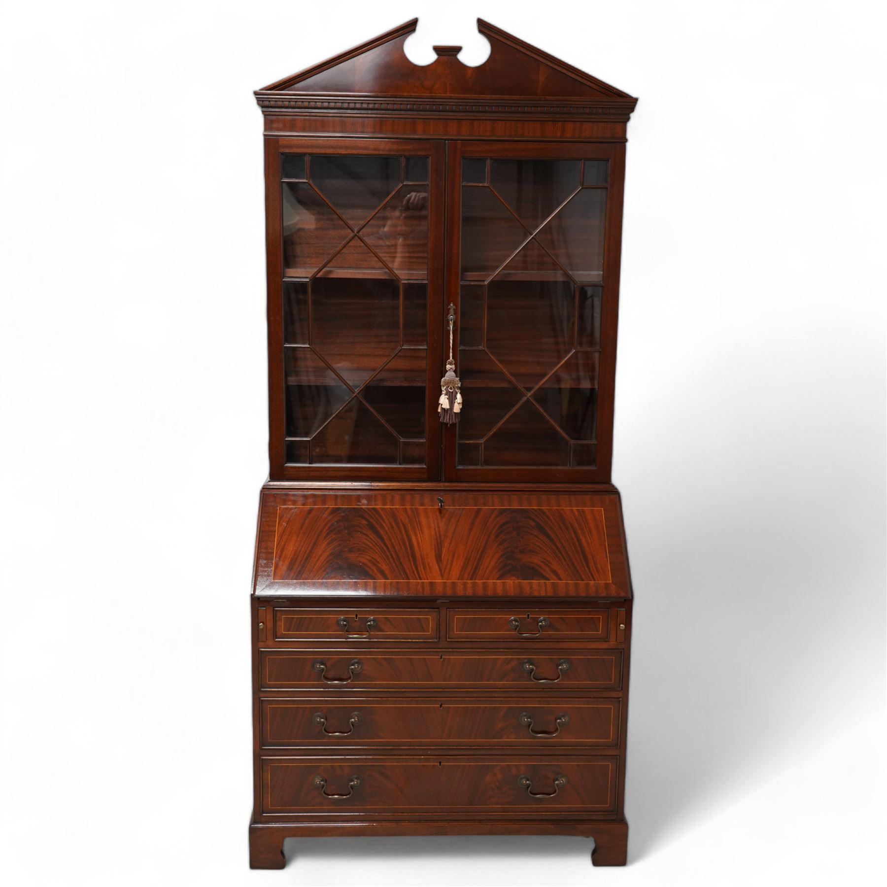 Georgian design inlaid mahogany bureau bookcase, broken pediment over dentil cornice, two astragal glazed doors enclosing shelves, fall-front with fitted interior over two short and three long drawers