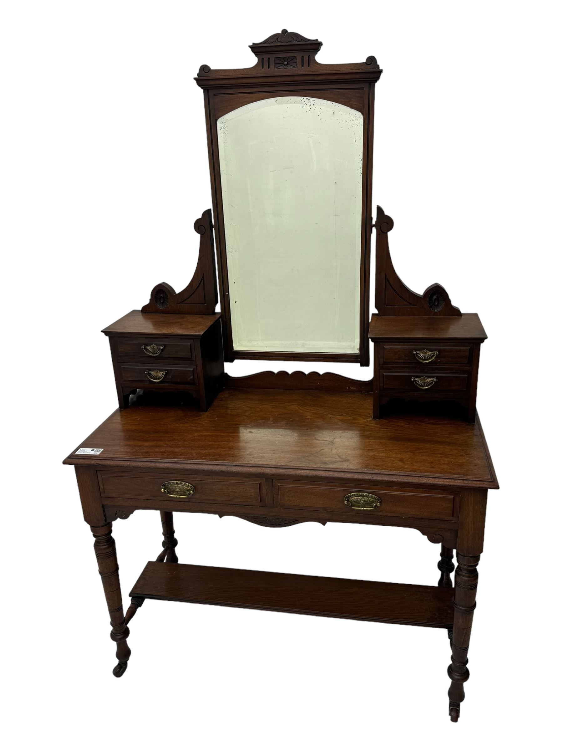 Late Victorian walnut dressing table, raised bevelled swing mirror over small trinket drawers, rectangular moulded top, fitted with two drawers, on turned supports united by undertier 