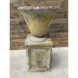 Cast stone vase shaped urn, mounted on square plinth