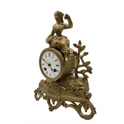 French - late 19th century 8-day mantle clock, in a spelter case with a solitary maiden seated above the drum movement, with an enamel dial, Roman numerals, minute markers and spade hands, twin train countwheel striking movement striking the hours and half hours on a bell. With pendulum and key. 