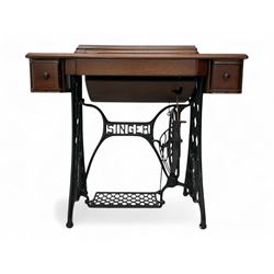 Singer - early 20th century treadle sewing machine, housed in a wooden cabinet with hinged...