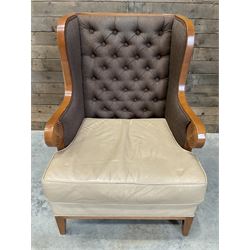 Walnut finish framed wing back armchair upholstered leather and buttoned fabric