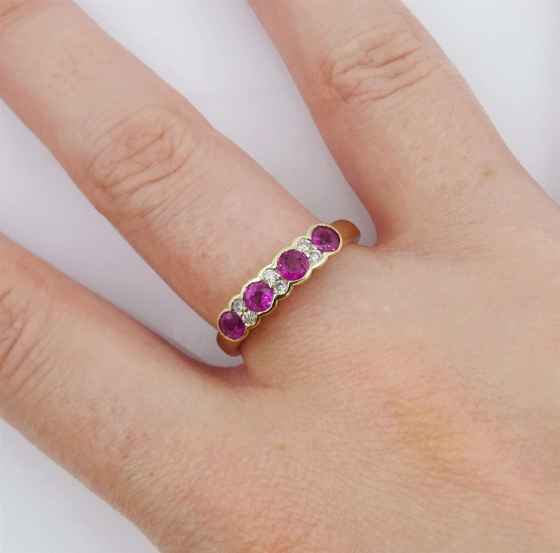 9ct gold ruby and diamond ring, four round cut rubies, each with two round brilliant cut diamonds set between, hallmarked