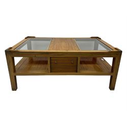 Starbay Tobago cherry wood coffee table, rectangular top with two inset glass panels, central drawer with louvred front and brass handles, flanked by open shelving, raised on square supports with metal corner brackets