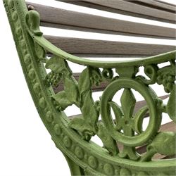 20th century cast iron and wood slatted 'Lilly of the Valley' garden bench, cast iron bench ends of scrolled form decorated with trailing foliage and flower heads, on scrolled supports 