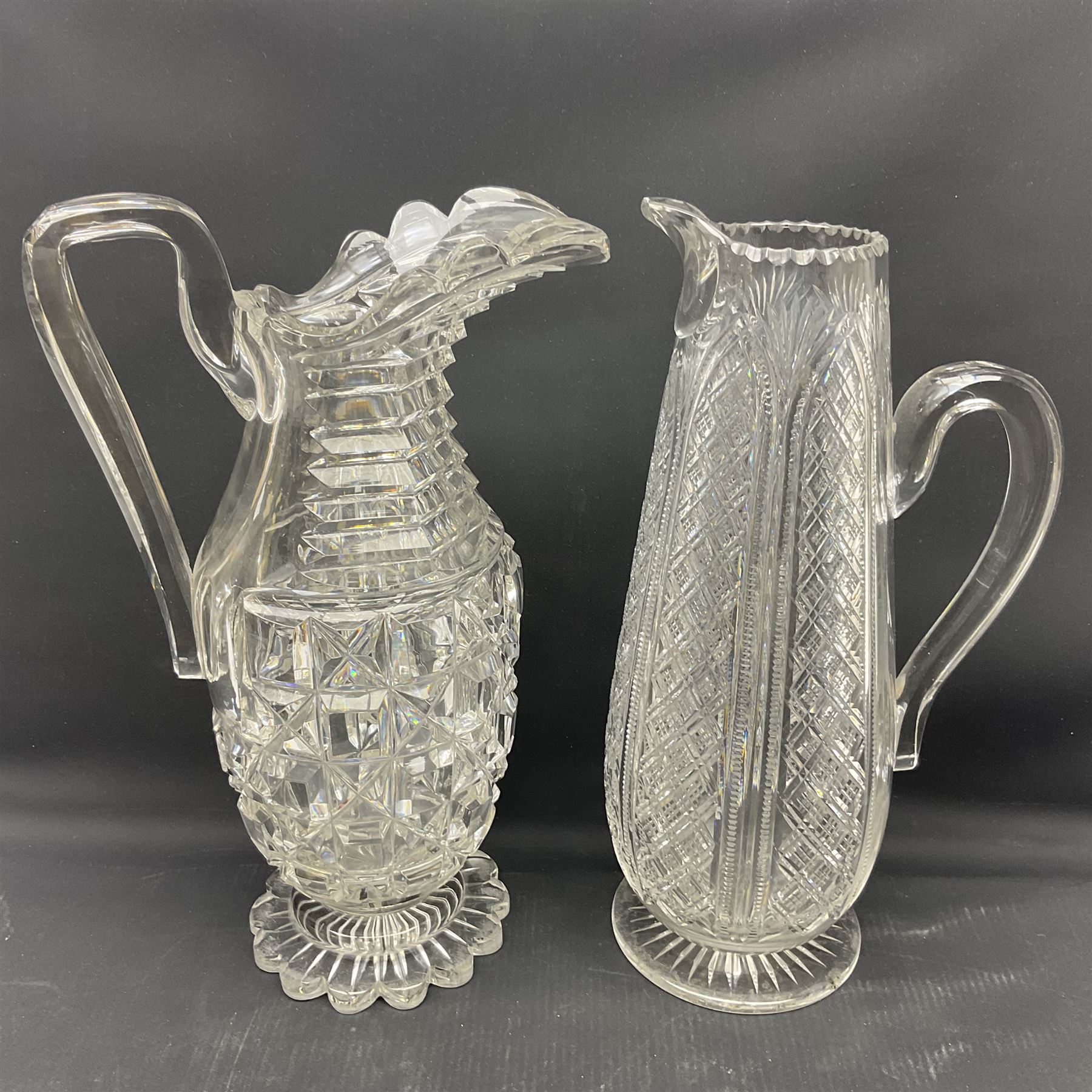 Collection of 18th century and later cut glass, including a pair of Victorian onion shaped decanters with elongated necks and hobnail cut decoration, together with a similar jug, of tapering form with C handle and an Georgian cut glass jug, with stepped decoration to neck and square cut decoration to body, tallest jug H30cm