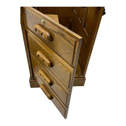 Early 20th century oak tambour roll-top desk, the top with fitted interior including drawers, pigeonholes and compartments, the twin pedestals fitted with four drawers with carved handles, supported by plinth base 