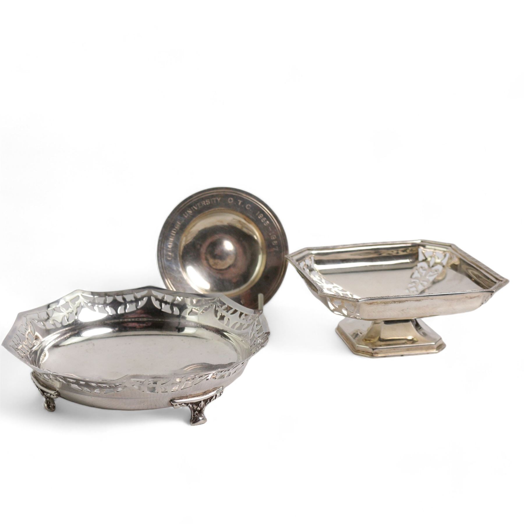 Silver circular sweetmeat dish with pierced border D16cm London 1930, another of square form with cut off corners W12cm Birmingham 1937 and a Cambridge University silver saucer dish (3)