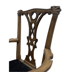 Unusual 18th century mahogany elbow chair, the shaped cresting rail with projecting shell carved ears, pierced and scroll carved splat over drop-in upholstered seat, shaped arms with ball and claw carved terminals, the seat rails carved with shell cartouches, on foliate carved cabriole supports with ball and claw feet 