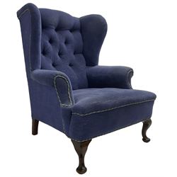 Early 20th century wingback armchair, upholstered in buttoned blue fabric, rolled and scrolled arms, on cabriole feet