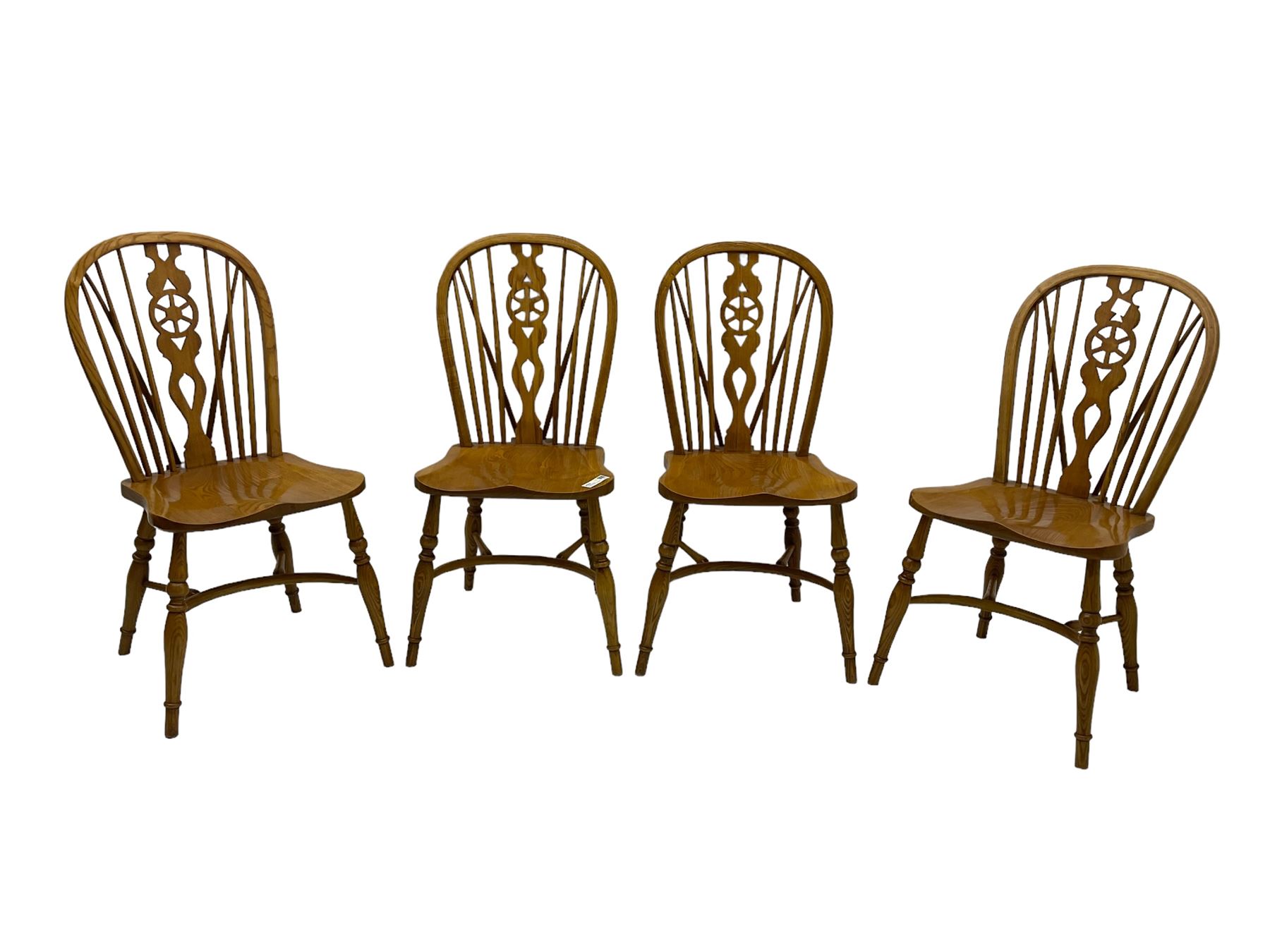 Set of four elm Windsor dining chairs, hoop and stick back with shaped wheel splat, dished seat on turned supports united by crinoline stretcher 