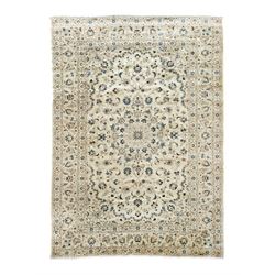 Persian Kashan ivory ground rug, sparsely decorated field with swirling leafy branches and...