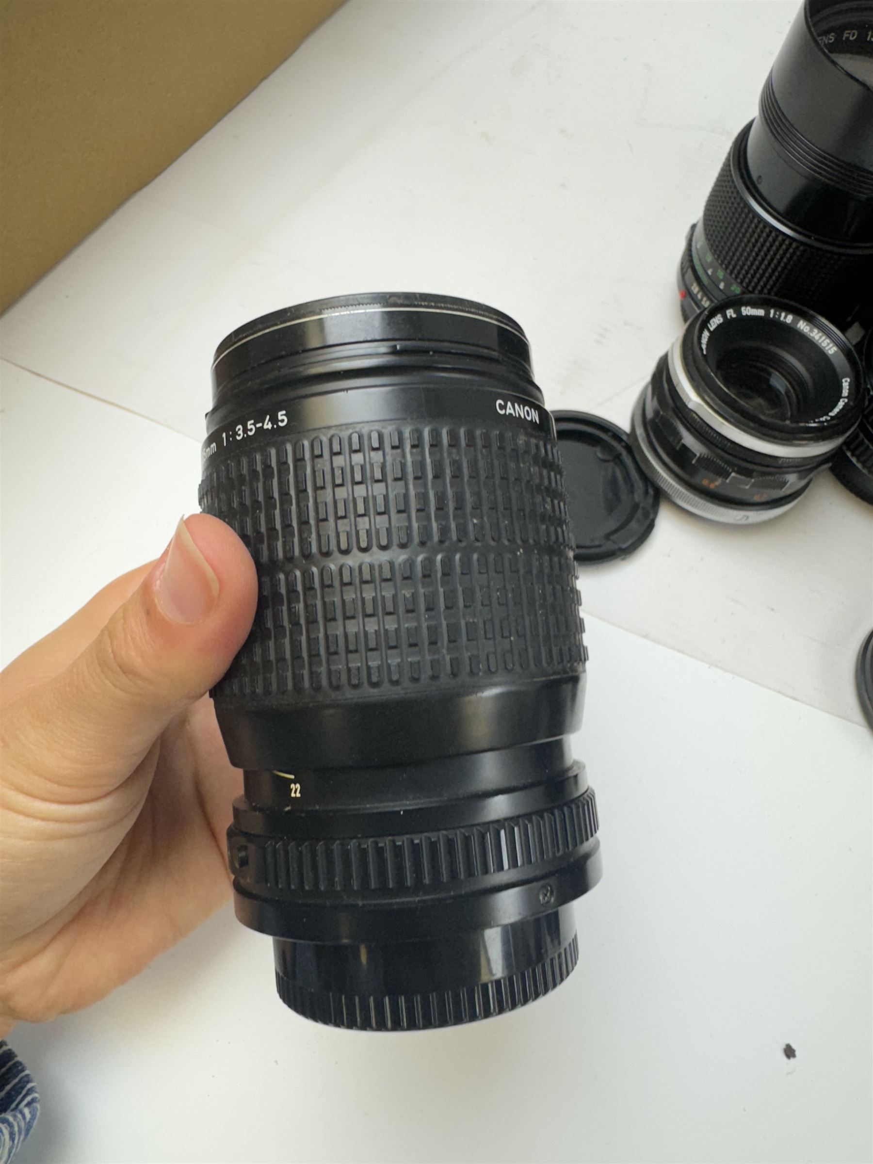 Seventeen Canon camera lenses, mostly FD examples, including 28-85mm 1:4 serial no, 49881, 35-105mm 1:3.5-4.5 serial no. 87632 and 135mm 1:2.8 serial no. 48336, one boxed