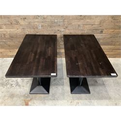 Two dark walnut rectangular console tables, on black metal bases