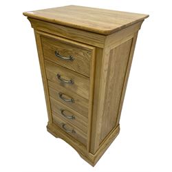 Contemporary light oak pedestal chest, moulded cornice and chamfered rectangular top with rounded fronts, over five drawers with metal handles and cock-beaded surrounds, on bracketed plinth base