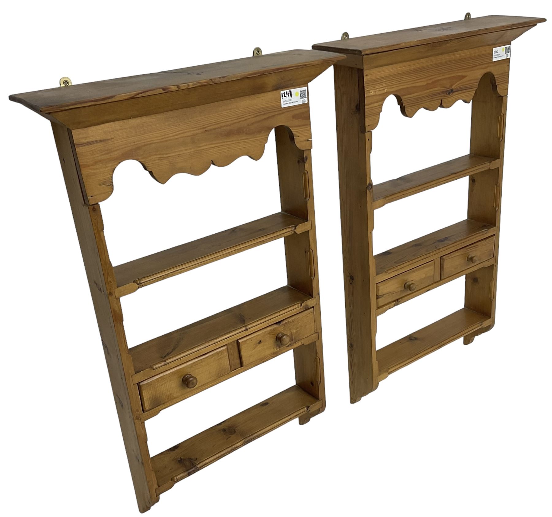 Pair of 20th century small waxed pine plate racks, shaped apron over three shelves and single drawer styled as two