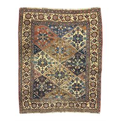 Caucasian pale ground rug, the field divided into lozenges each decorated with stylised pl...