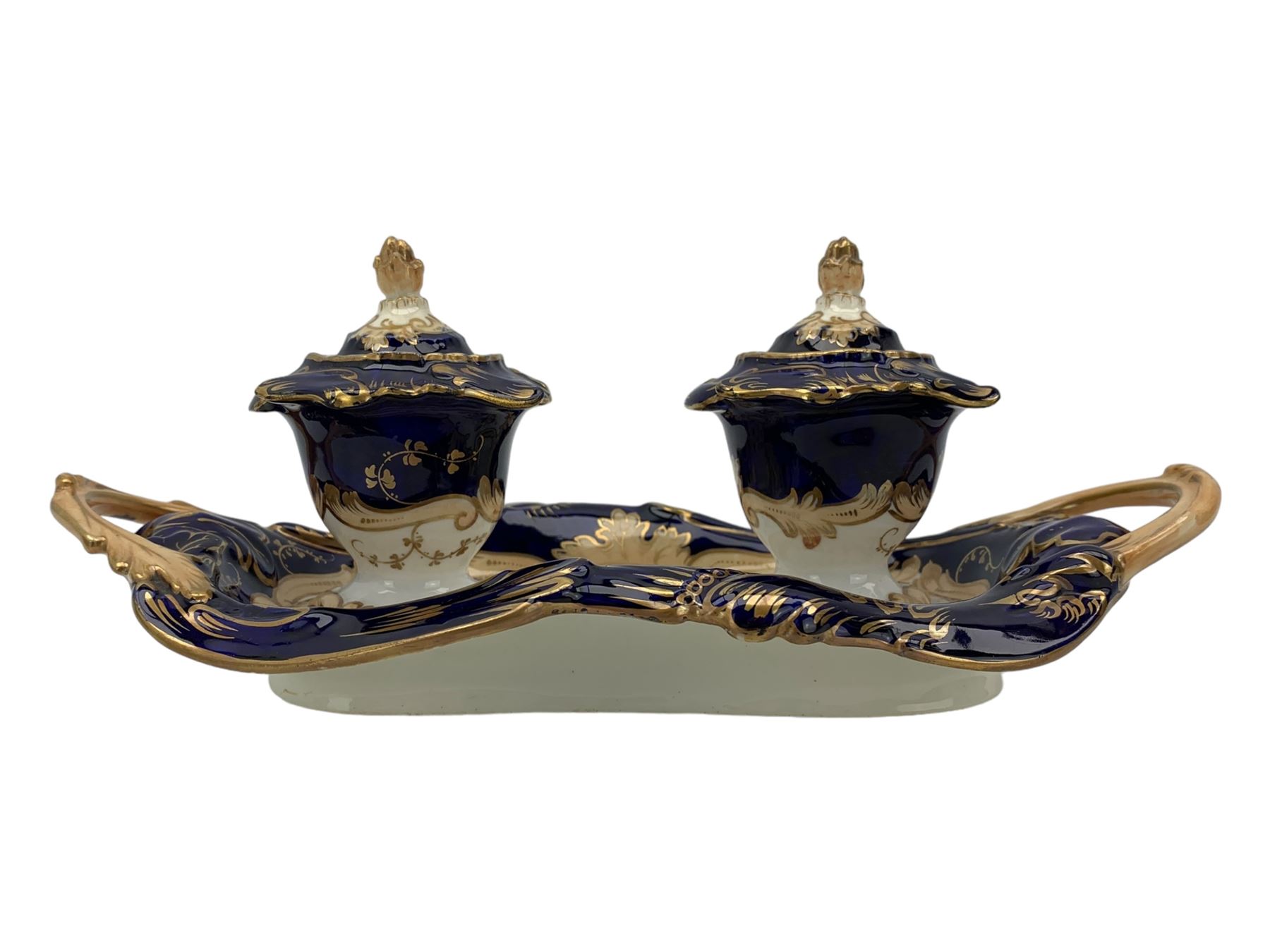 19th century porcelain inkstand, the oblong twin handled base centrally painted with a floral bouquet, flanked by two footed inkwells and covers, with rococo-inspired acanthus moulded borders and handles, pattern no. 2/3339, L26.5cm 