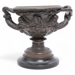 Pair of 19th/ early 20th century bronze 'Warwick' vases, after the antique, of typical form, cast with Bacchic masks and Thyrsus, on a lion pelt-cast ground, with egg and dart and beaded borders and twin reeded bifurcated branch handles, on square marble plinths, H17cm x W20cm