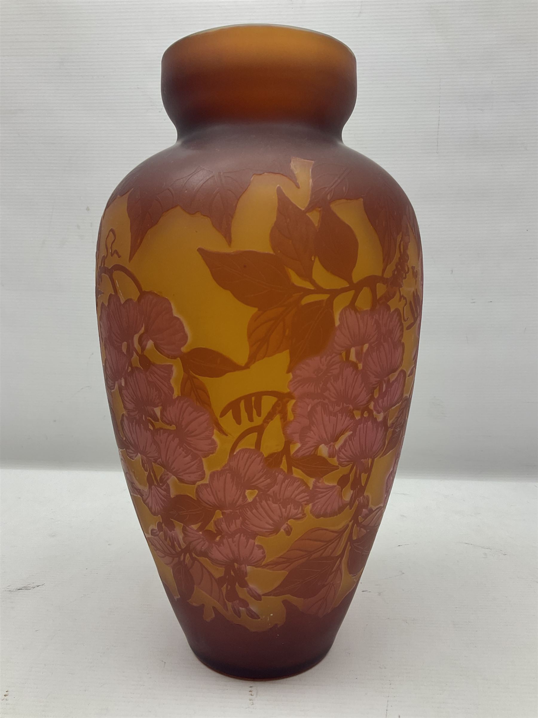 Art Nouveau style glass vase, in the style of Galle, the tapering body decorated with trailing red and pink foliage on a yellow ground, H33cm