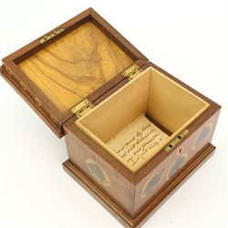 E Dommett - Early 20th century mahogany box, the hinged lid inlaid with laburnum heart above a frieze inlaid with roundels in laburnum and holly, the interior of the lid in olive wood and the base lined with holly, signed 16cm x 12cm x 13cm and with a hand written note identifying the woods used.