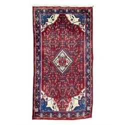 Persian Herati crimson ground rug, the busy field decorated with a central lozenge medalli...