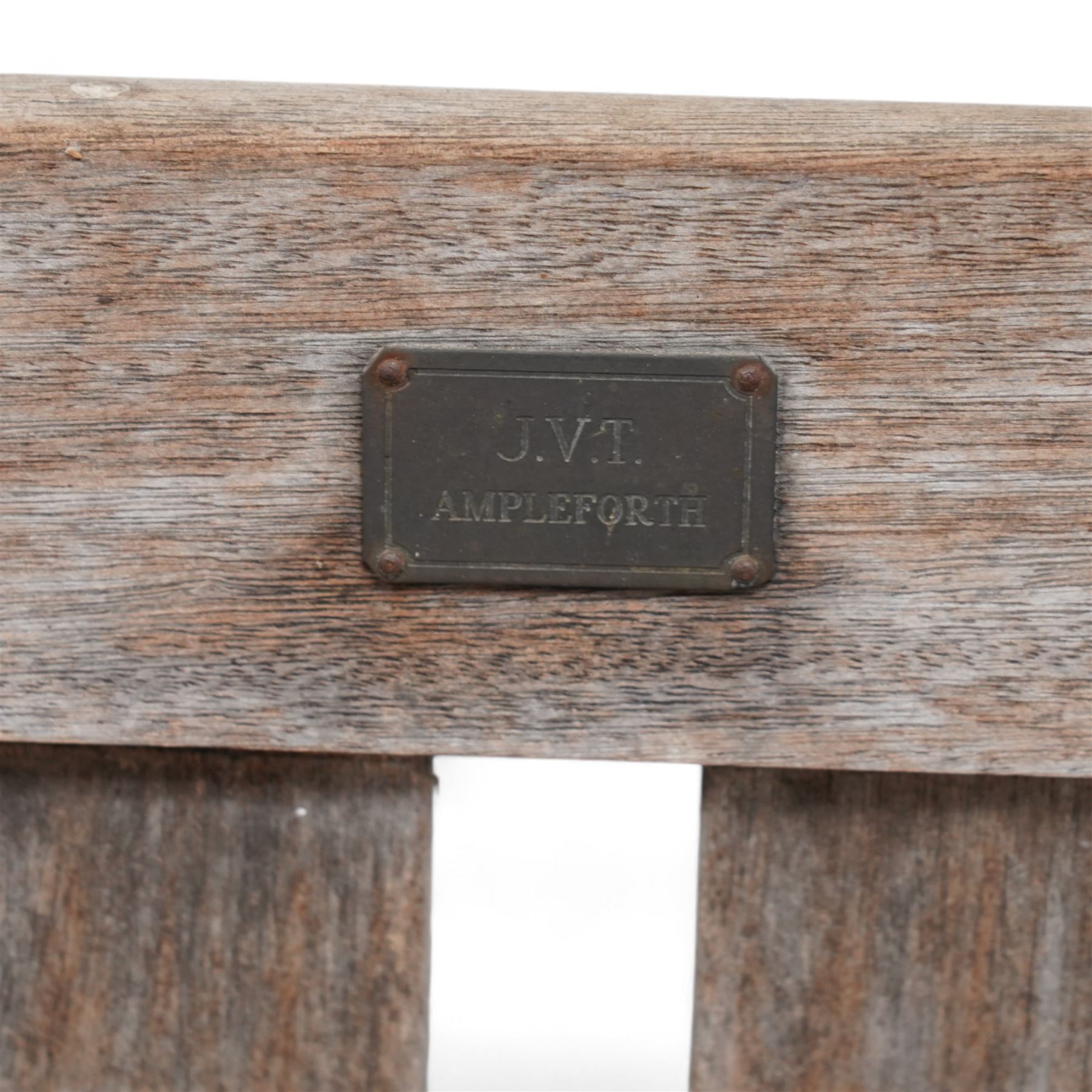 'J.V.T. Ampleforth' - teak garden bench, plain cresting rail with applied maker's plaque over slatted back and seat, on square supports 