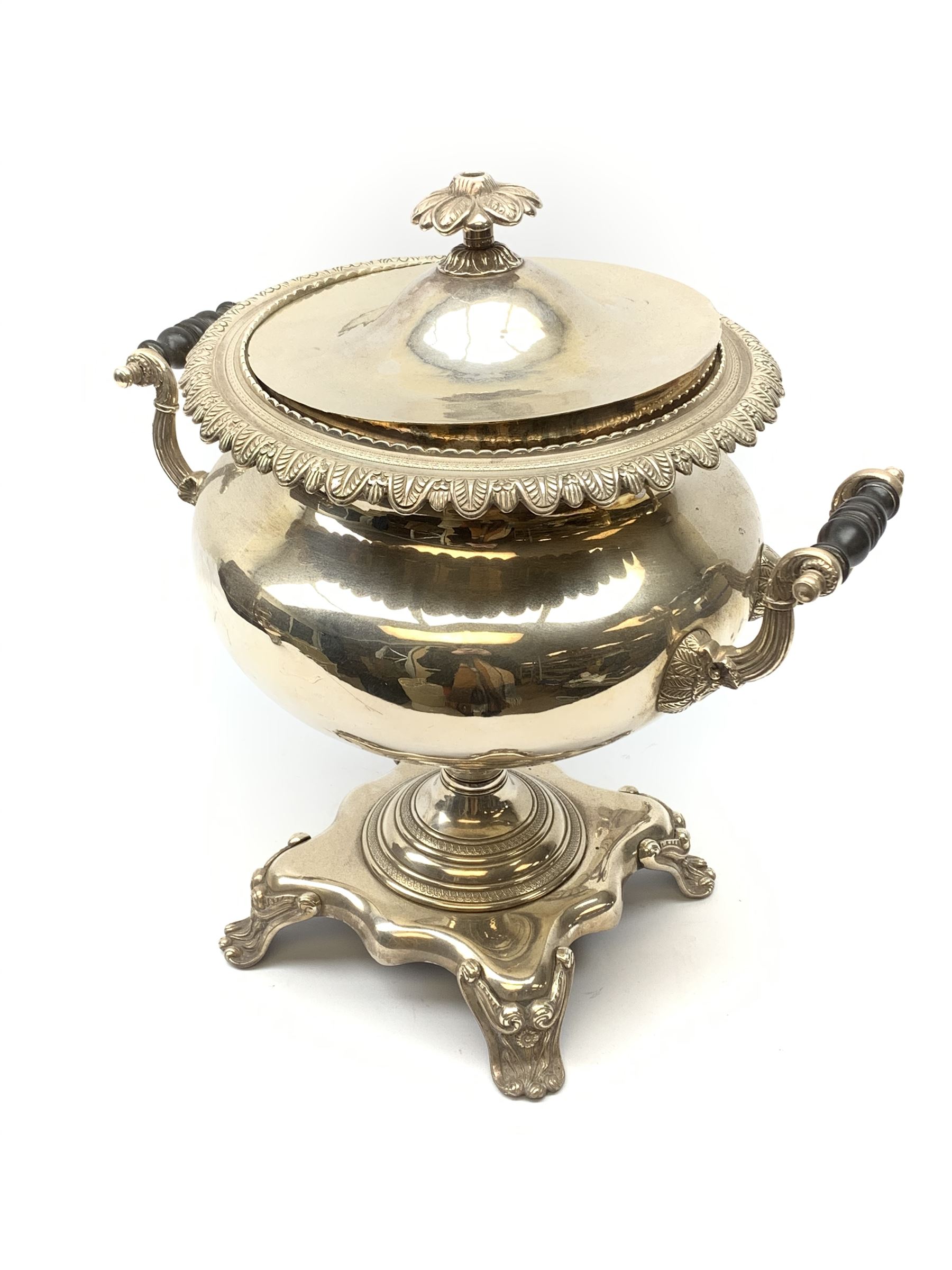 A 19th century silver plated hot water urn and cover, the twin handles with ebonised insulators, the body with foliate detail, and raised upon a base supported by four scroll feet, the cover marked beneath Parkinson's 70 Oxford St London, H40cm. 