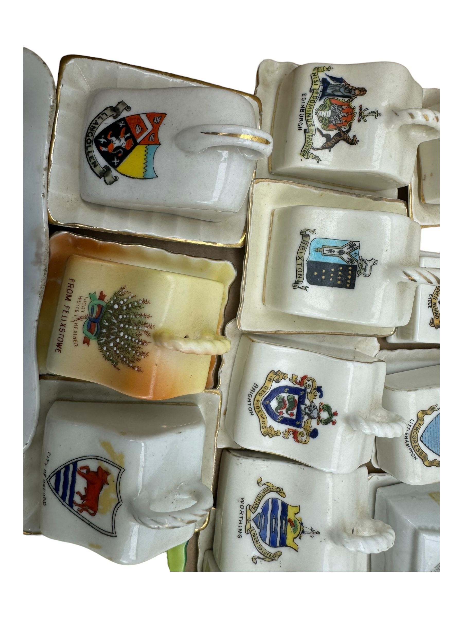 Collection of crested ware miniature cheese dishes and covers, including one by Goss, in one box