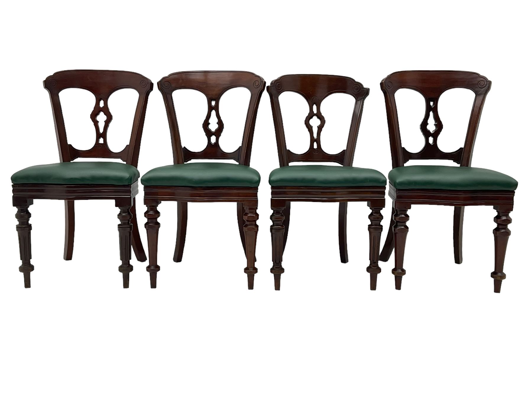 Matched set of twelve Victorian mahogany dining or boardroom chairs, the shaped cresting rail decorated with scrolled decoration, upholstered drop-on seats upholstered in green fabric, on turned supports  