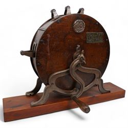 Edwardian knife polisher by Spong and retailed by B & E Bushell, York, on cast iron base and mounted on later wooden stand, H51cm x L67cm