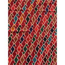 Southwest Persian Qashqai Kilim crimson ground rug, decorated with a repeating geometric pattern of interlocking diamond motifs in red, green, blue, and brown, enclosed by a deep brown border with stylised floral motifs and colourful fringe accents