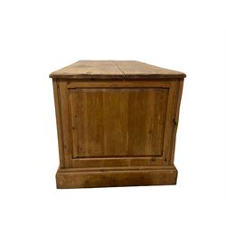 20th century waxed pine kneehole desk, rectangular top over nine drawers with cup handles, on moulded plinth base