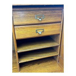 Early 20th century oak tambour roll-top desk, the top with fitted interior including drawers, pigeonholes and compartments, the twin pedestals fitted with four drawers with carved handles, supported by plinth base 