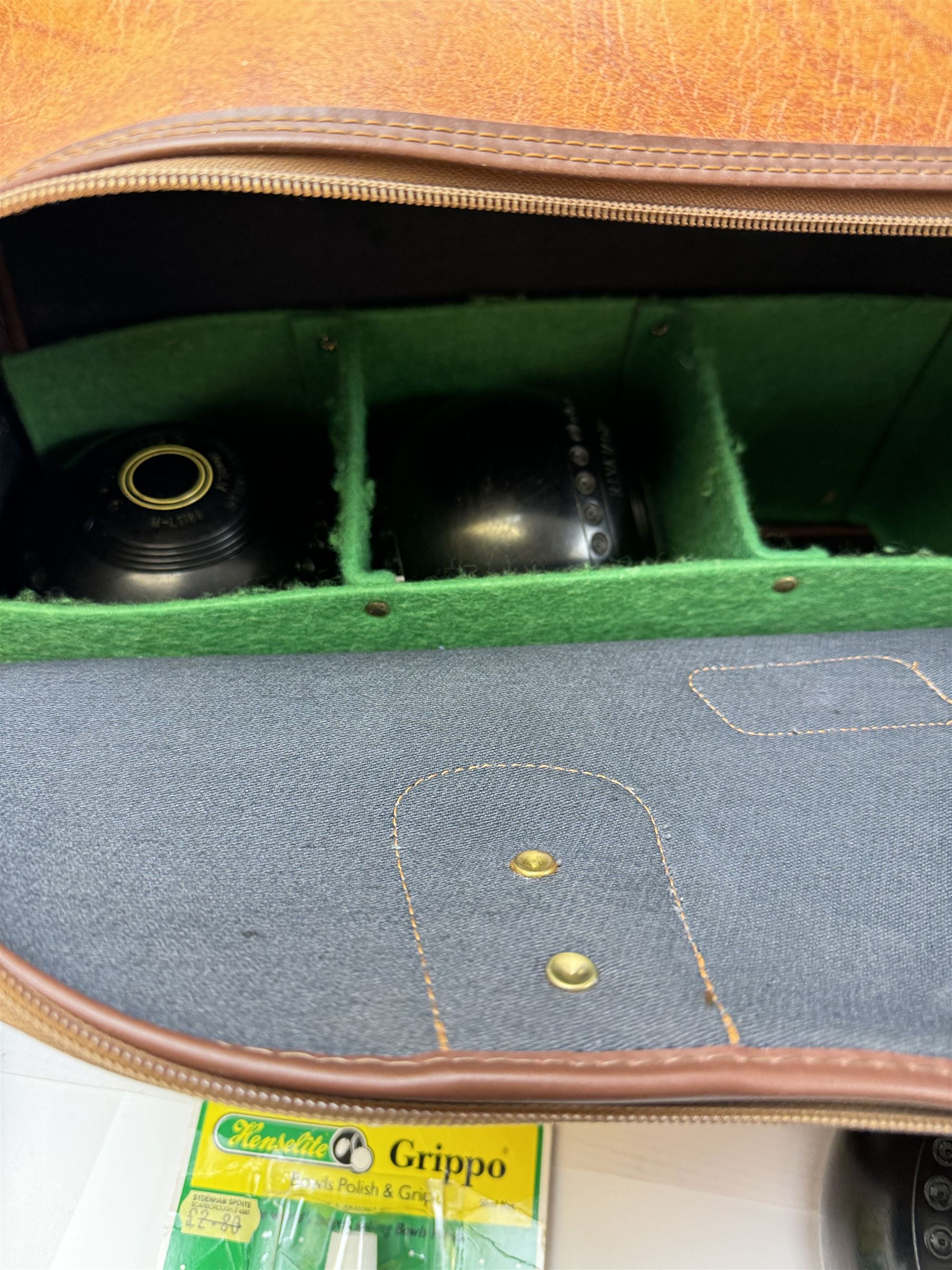 Two sets of flat green bowls, to include a ladies and gentlemans set, both contained within bowling bags