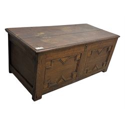 18th century oak blanket box, rectangular form with a hinged lid, the front decorated with raised geometric panelled mouldings, fitted with a central lock plate, raised on bracket feet