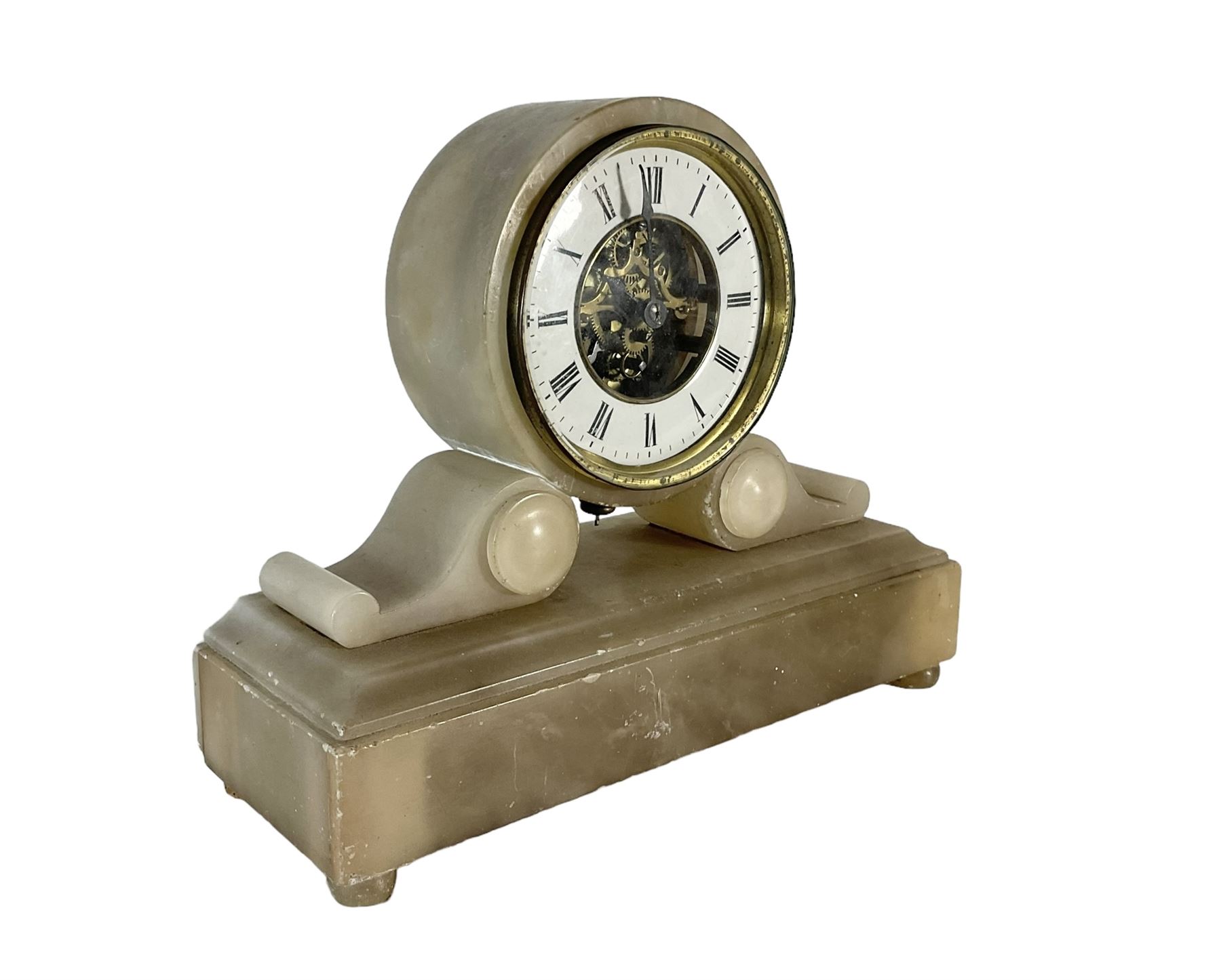 French - late 19th century 8-day mantle clock in an alabaster case,  with a drum movement raised on scroll supports and stepped plinth, open dial displaying the skeleton movement, escapement and motion work, enamel chapter with Roman numerals and spade hands enclosed within a glazed brass bezel, single train tick tac escapement with integral pendulum, wound and set from the front.