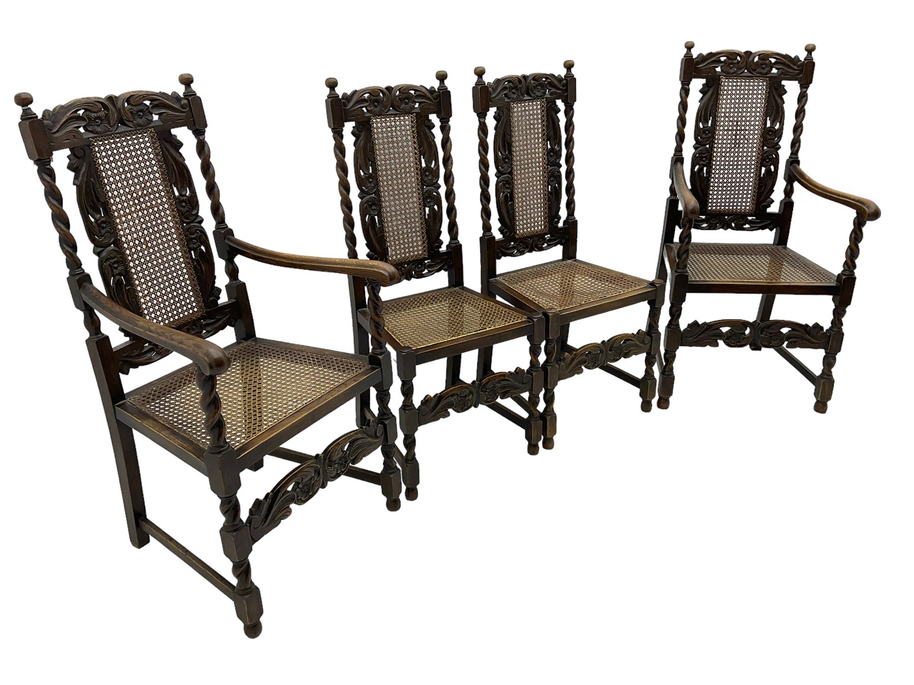 Set of seven (5+2) 19th century Carolean design oak dining chairs, scroll leaf and flower head carved cresting rail over spiral turned uprights and cane work back, the cane work seat on spiral turned supports united by plain stretchers, scrolled leaf carved middle rail 