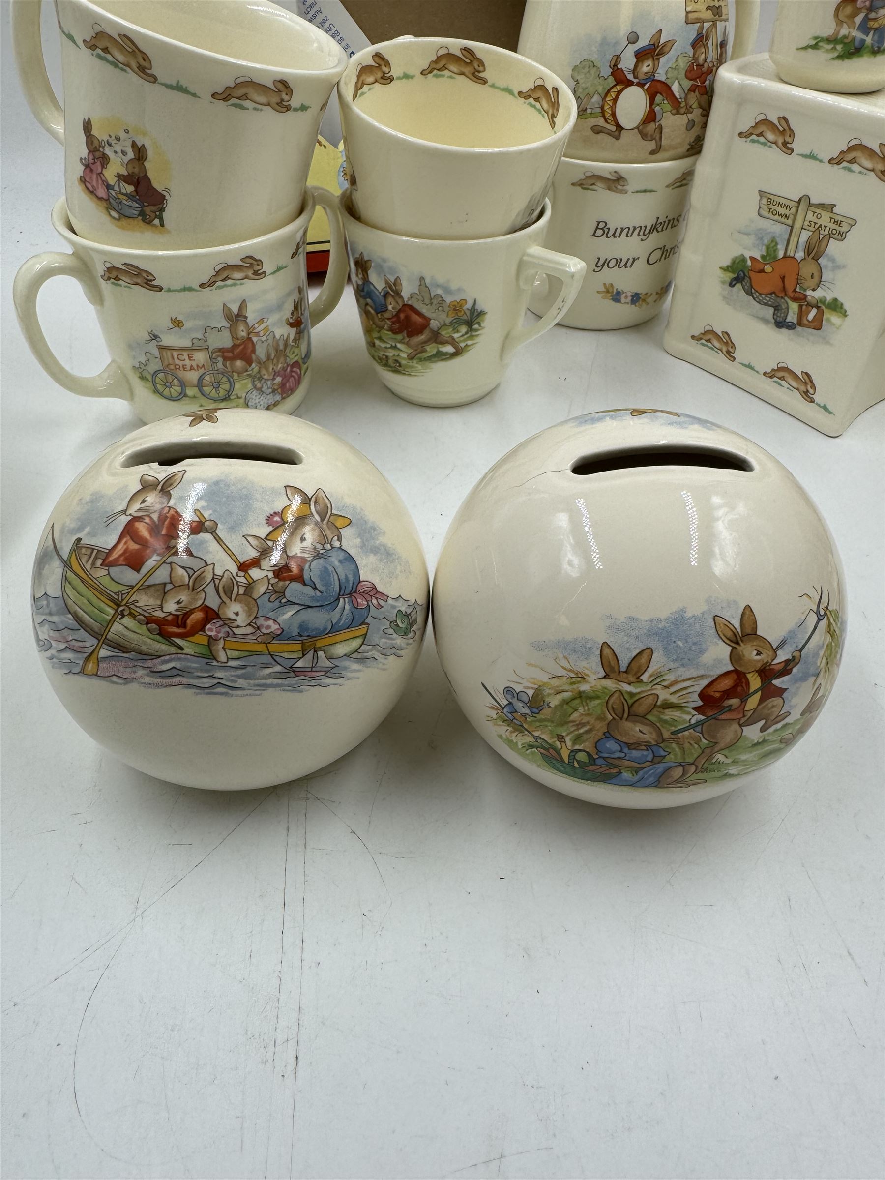 Royal Doulton Bunnykins teawares, including teacups and saucers, egg cup, money boxes etc (12)