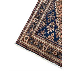 Persian Joshaghan peach and blue ground rug, central stepped lozenge medallion surrounded by bunches of floral motifs, repeating border decorated with stylised plant motifs, within multiple guard stripes