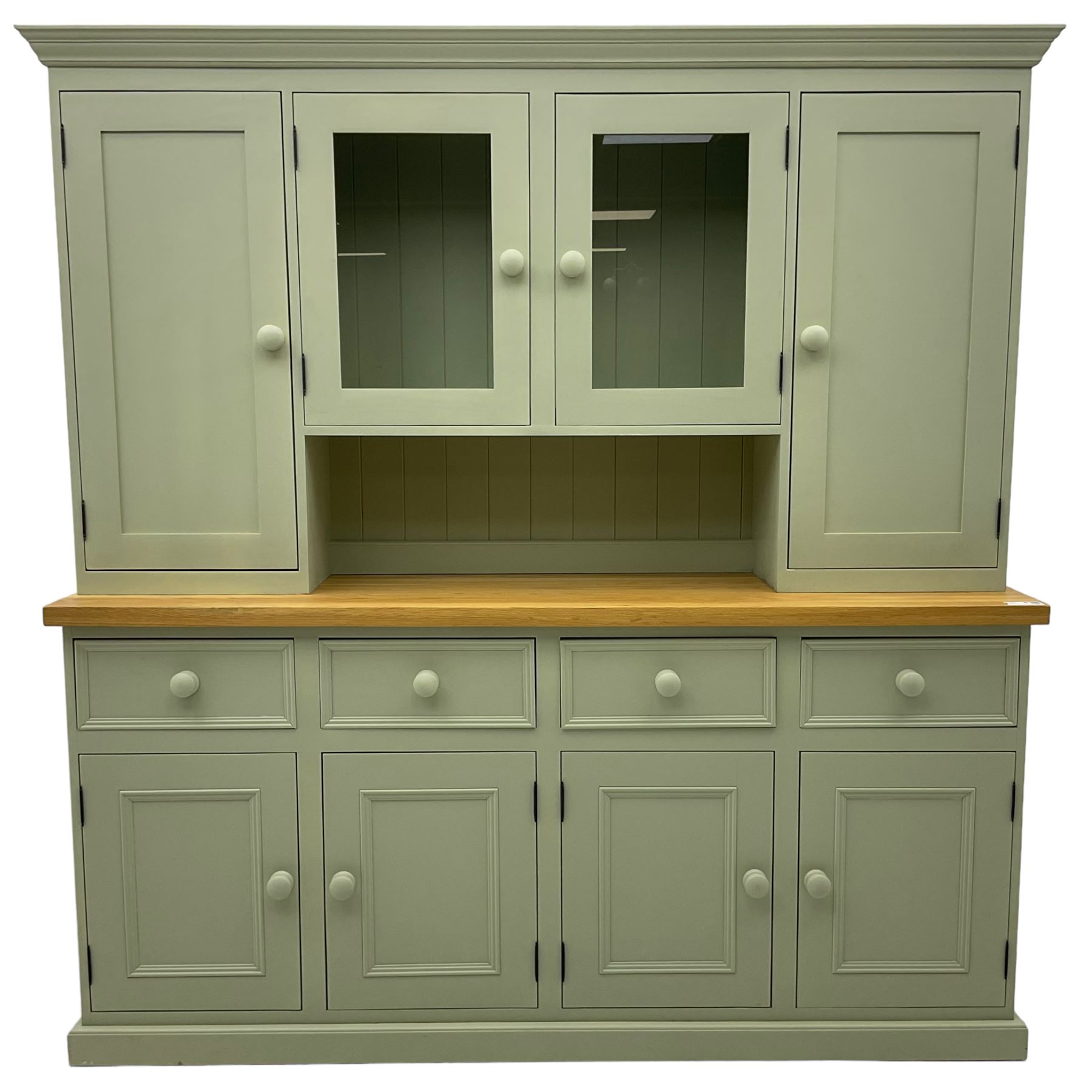 Painted kitchen dresser, projecting moulded cornice over central glazed display doors and flanking panelled cupboard doors, polished oak rectangular top over four drawers and four cupboards, on moulded plinth base, in laurel green paint finish 