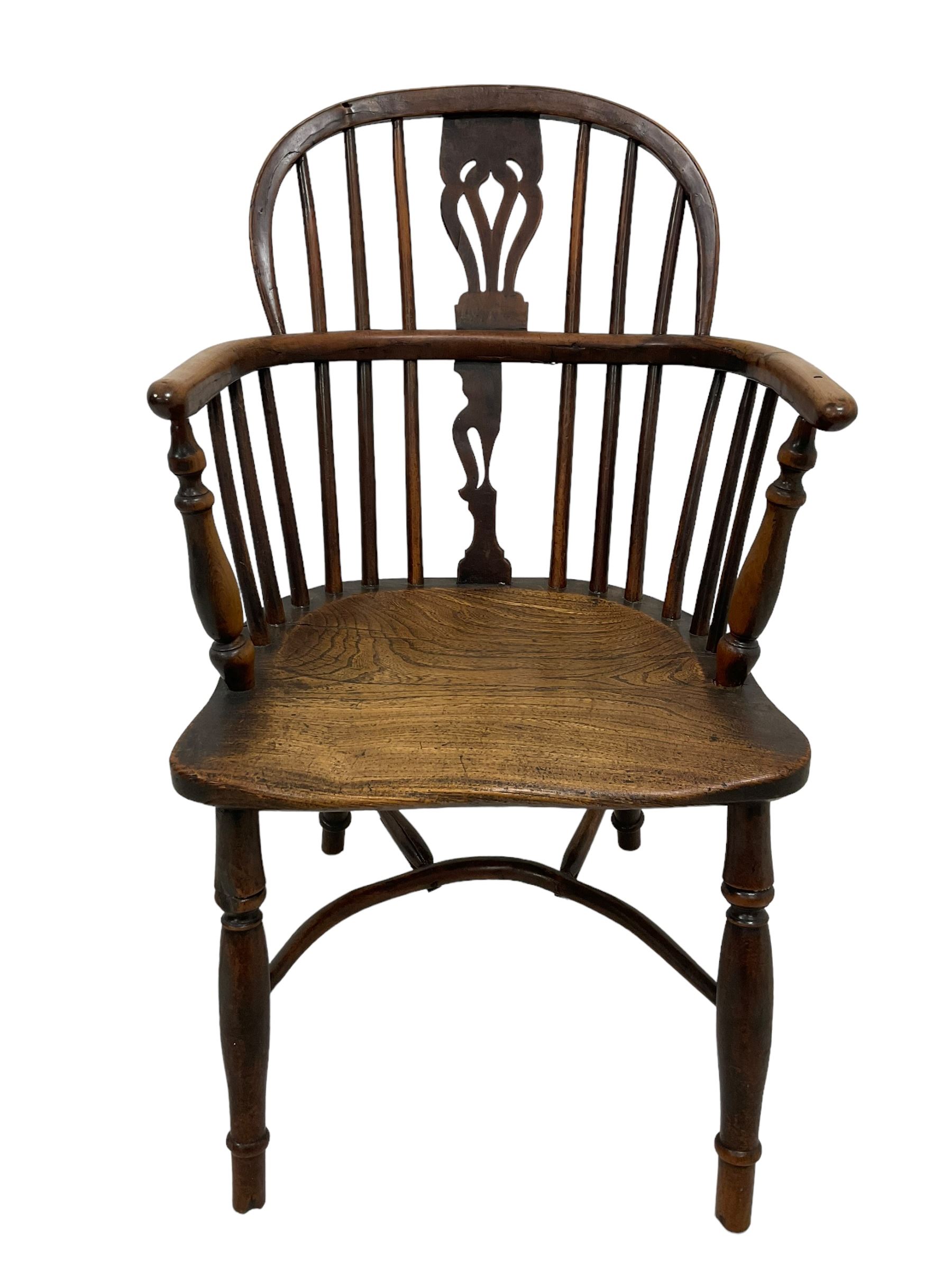 19th century yew wood and elm Windsor chair, low hoop stick back with pierced splat, dished seat raised on ring turned supports joined by crinoline stretcher