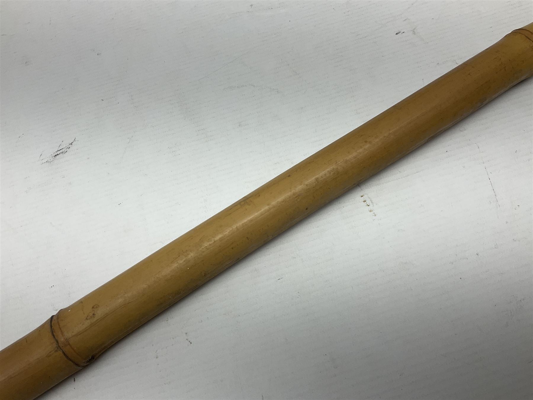 Bamboo cane torch, the pierced brass cover opening to reveal a wick, H144cm